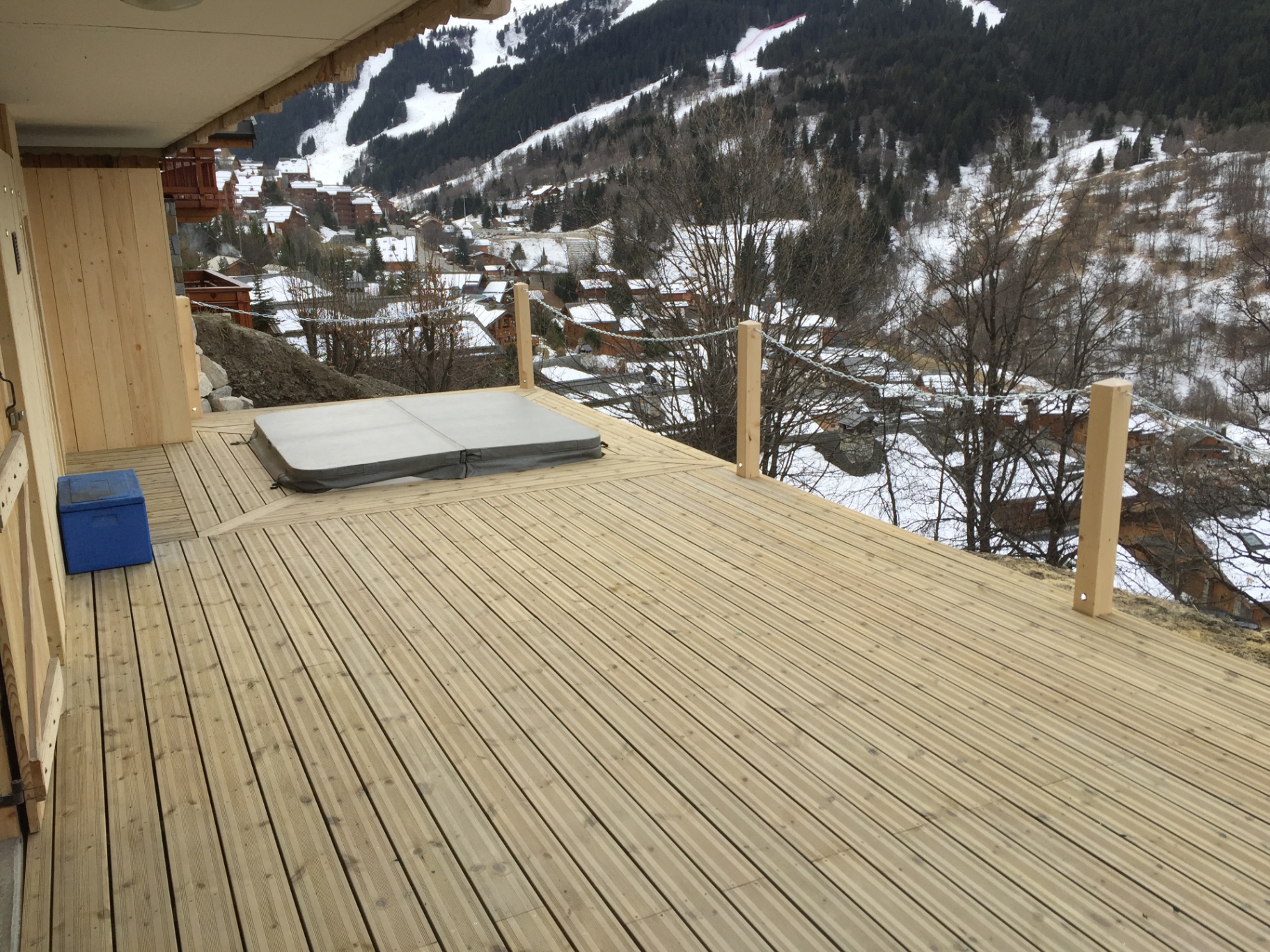 Chalet sun terrace with covered hot tub and valley views