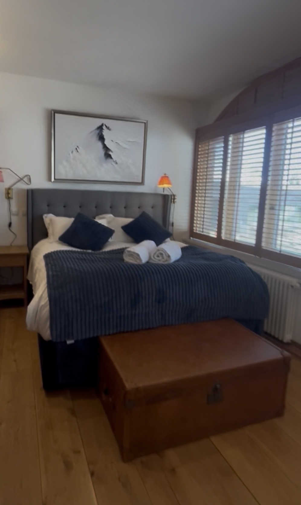 Freshly prepared chalet bedroom with linen and towels ready for guests