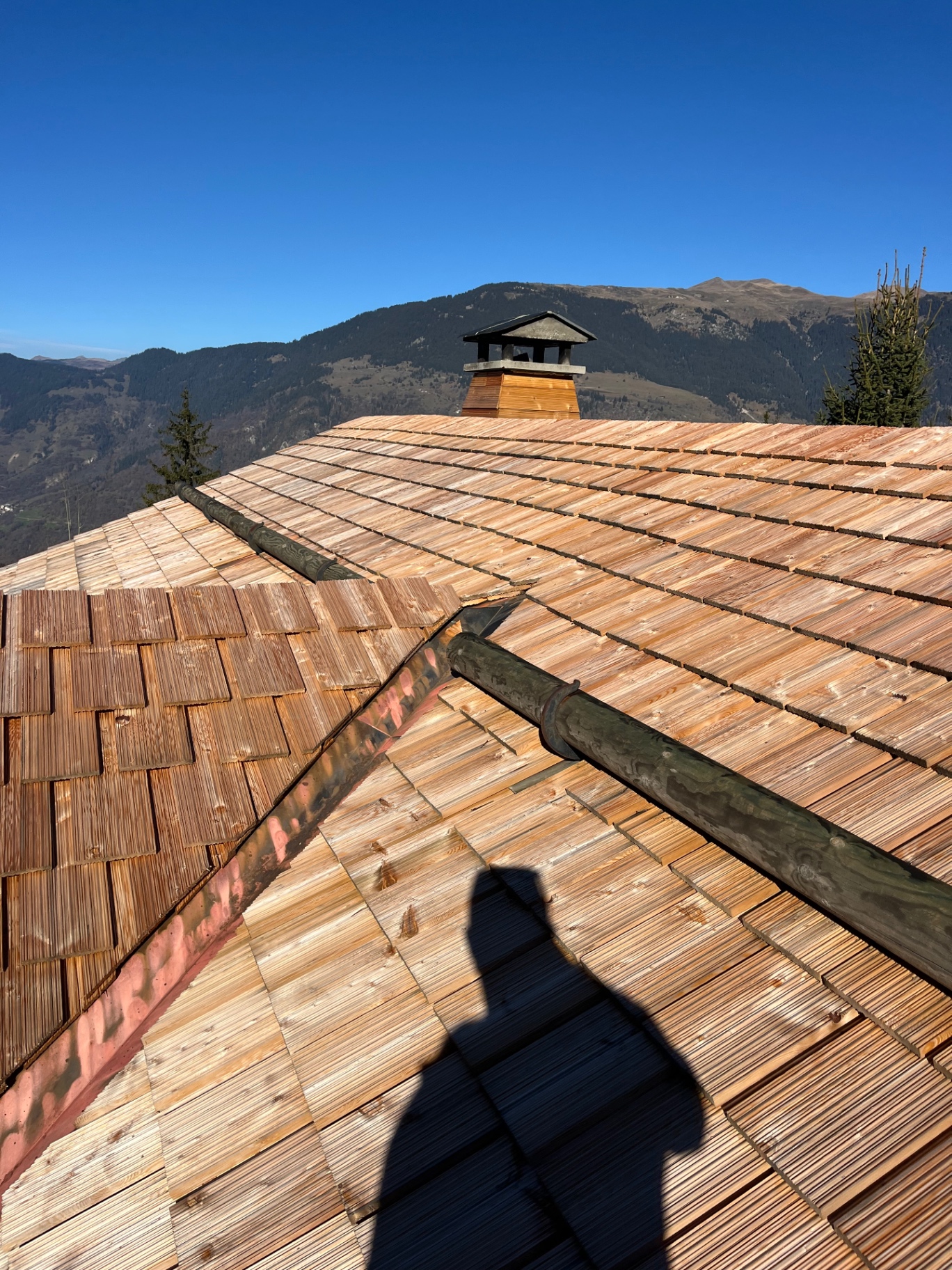 New timber shingle roof being laid on an alpine chalet